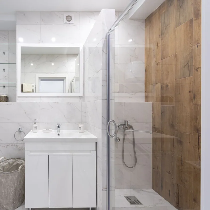 Custom tiled shower with built-in niche by Safe Haven Flooring & Tiling