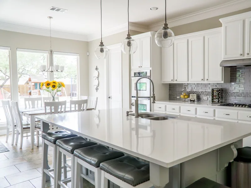 Large-format tile flooring in a sunlit open-plan home