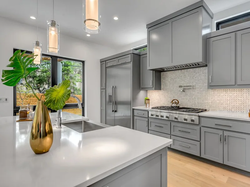 Mosaic tile accent wall behind a kitchen range